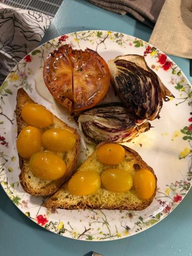 a plate of food with bread and fruit on it at L'Amarena Garden House in Matera