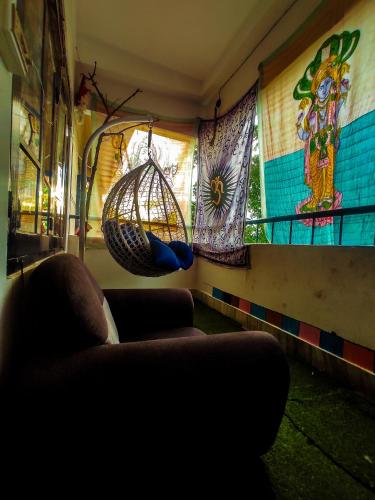 a living room with a couch and a hanging basket at The Hidden Gem Guwahati in Guwahati
