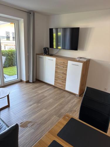 a living room with a tv and a couch and a table at Ferienwohnung Imbach in Kaprun