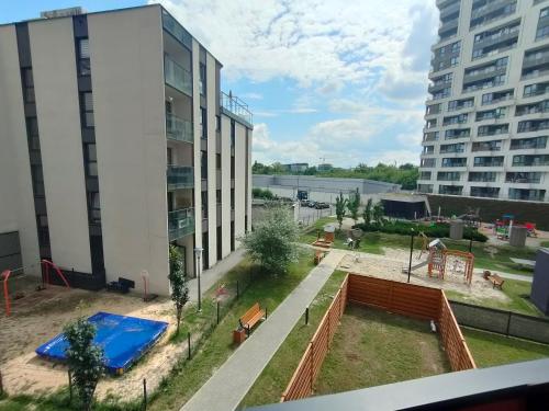 a view of a playground in front of a building at 3-Bedroom Apartment with 2 Free Parking Spots - TAURON ARENA in Kraków