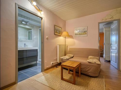 a living room with a couch and a sink at Gite La Bastide De La Coda in Châteauneuf-du-Rhône