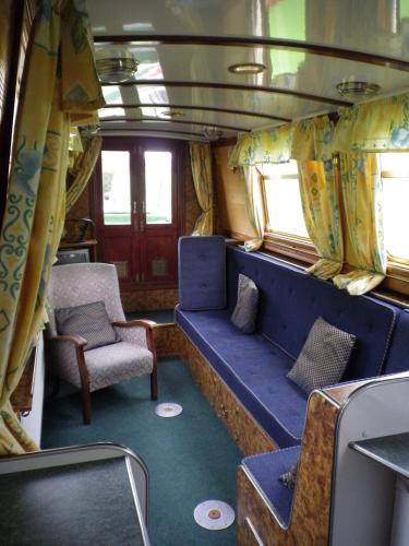 a train car with a blue seat and a chair at Stone - Boat - Sleeps 6 - Pet Friendly - 85ws in Stone