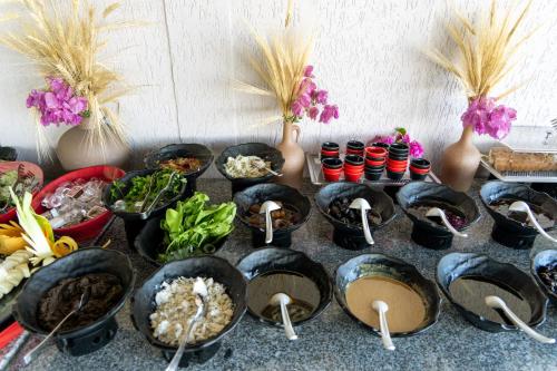 a table topped with bowls of food and vases at Brow City Kaş in Kas