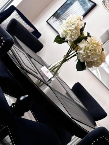 a vase with white flowers sitting on a table at Alex Court in Leixlip