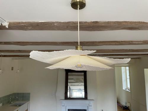 a large white ceiling light in a kitchen at Le Corps de Garde du château in Saint-Martin-des-Champs