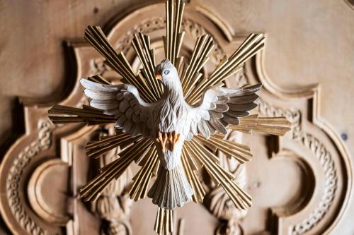 a statue of a bird on a wall at Boutique Hotel Eggele in San Candido