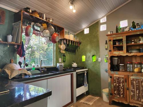 a kitchen with a counter and a sink and a window at Welcome to Sítio Arcanjos in Alto Paraíso de Goiás