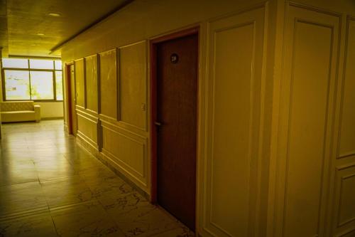 an empty hallway with an open door and a room at Hotel Jaisal Inn - Pure Veg in Jaisalmer