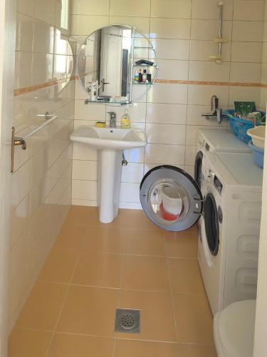 a bathroom with a sink and a washing machine at Villa With Swimming Pool in Ulcinj