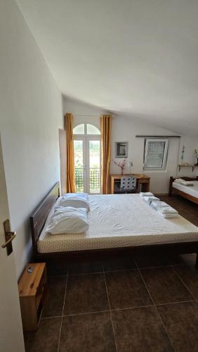 a large bed in a bedroom with a window at Villa With Swimming Pool in Ulcinj