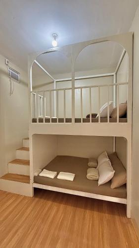 two bunk beds in a room with wooden floors at DM Guesthouse - Impasugong Bukidnon in Impasugong