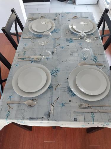 a table with plates and wine glasses on it at Beautiful 2-room apartment - Meaux - near Disneyland in Meaux