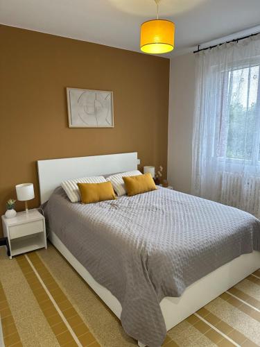 a bedroom with a large bed and a window at Gîte familial Gers 12 pers in Fleurance