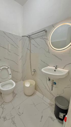 a bathroom with a toilet and a sink at DM Guesthouse - Impasugong Bukidnon in Impasugong