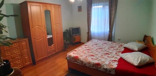 a bedroom with a bed and a dresser and a television at Садиба Сергія in Sinyak