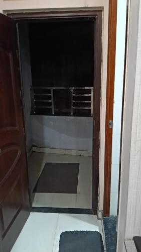 a glass door of a room with a shelf at Hotel JD Inn 