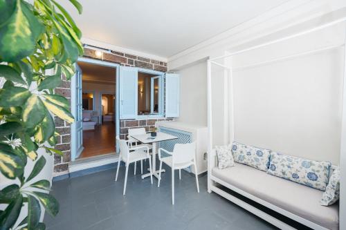a living room with a couch and a table at Kastro Suites in Fira