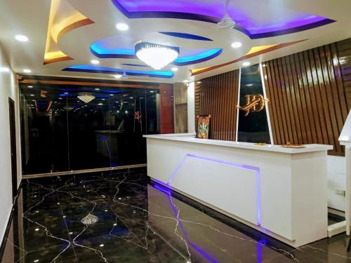 a lobby with a bar with purple and blue lights at Hotel JD Inn 