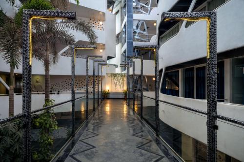 a corridor of a building with palm trees and a hallway at Days Inn & Suites by Wyndham Bengaluru Whitefield in Bengaluru
