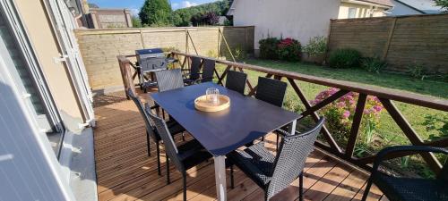 a table on a balcony with a candle on it at MAISON DE CAMPAGNE à LA MER pour un COUP DE COEUR in Étretat