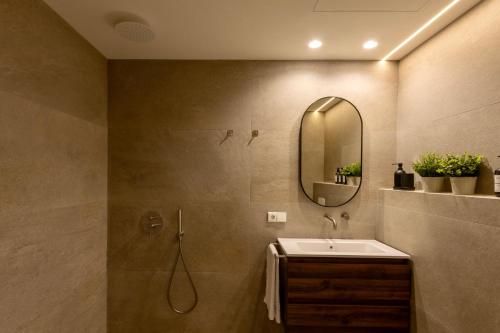 a bathroom with a sink and a mirror at Boutique Room - One Tower in Valencia