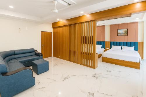 a hotel room with a bed and a couch at Hotel KARDHAR INN in Ambaji