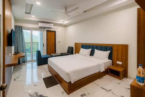 a bedroom with a bed and a living room at Hotel KARDHAR INN in Ambaji