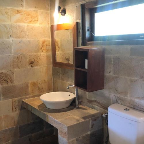 a bathroom with a sink and a toilet at Casa Nemo Beach Resort & Spa in Sabong