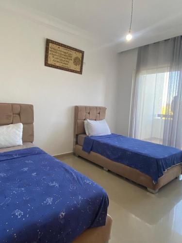 a bedroom with two beds and a window at Marina Golf Asilah in Asilah