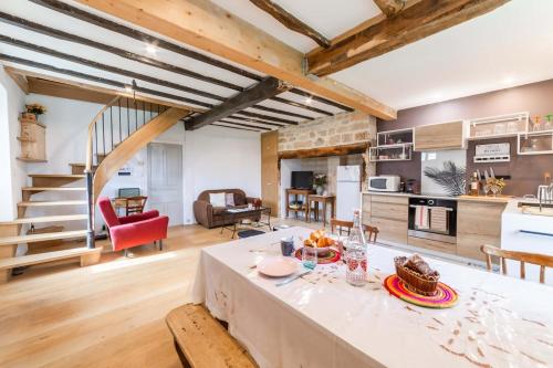 una cucina e un soggiorno con tavolo e sedie di La Maison d'Adèle a Vertou