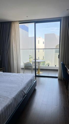 a bedroom with a bed and a large window at Seaview Stella The Arena in Cam Ranh International Airport