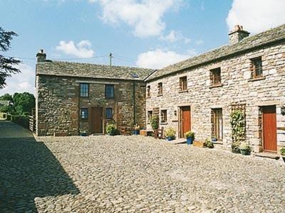 a large stone building with a stone driveway at Stone Barn - B6063 in Pooley Bridge