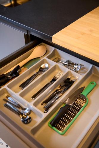 a tray with utensils in a drawer on a counter at Madama Hostel & Bistrot in Milan