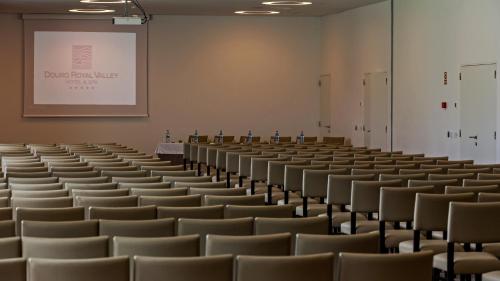 an empty lecture hall with chairs and a whiteboard at Douro Royal Valley Hotel & Spa in Riba Douro