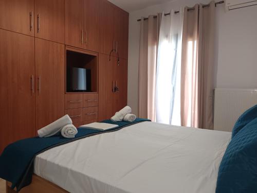 a bedroom with a large bed with towels on it at Villa Eleni in Kypséli