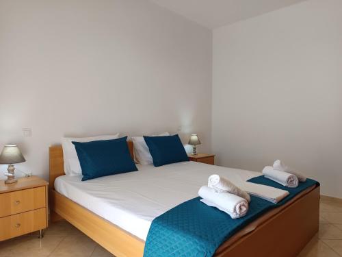 a bedroom with a bed with towels on it at Villa Eleni in Kypséli