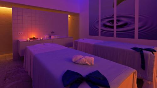 a bedroom with two beds with bow ties on them at Douro Royal Valley Hotel & Spa in Riba Douro