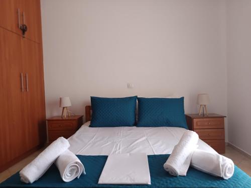 a bedroom with a bed with towels on it at Villa Eleni in Kypséli