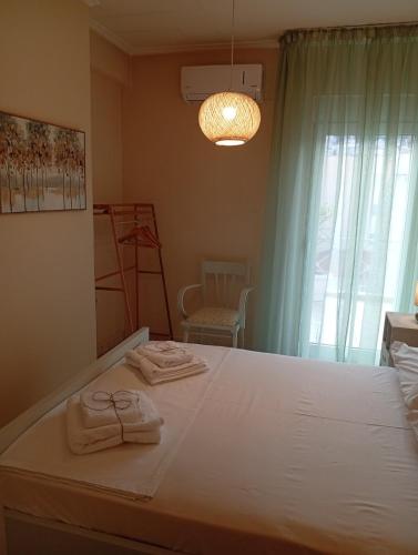 a bedroom with a large bed with towels on it at ChroMa View in Kavala