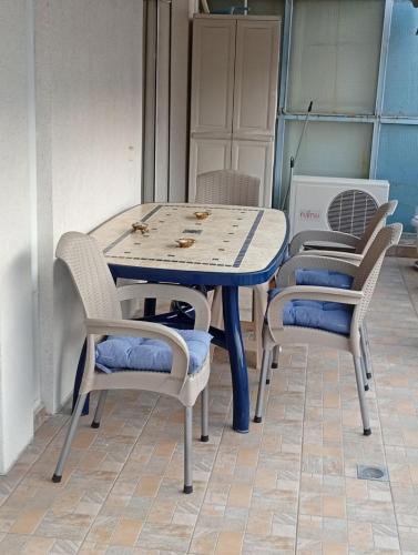 a table with four chairs sitting around it at ChroMa View in Kavala