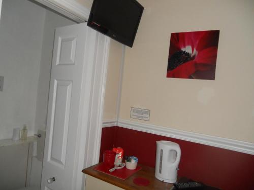 a room with a white door and a red wall at All Seasons Guest House in Great Yarmouth