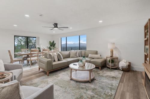 a living room with a couch and a table at All-New Luxe Stay Views, Sauna & Hot Tub villa in Holladay