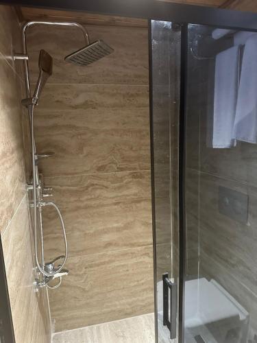 a shower with a glass door and a toilet at Babilyon Otel in Urfa