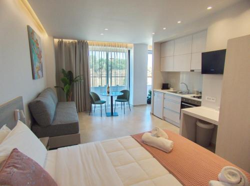 a room with a bed and a kitchen and a living room at Melina Apartments Sea & City in Chania Town