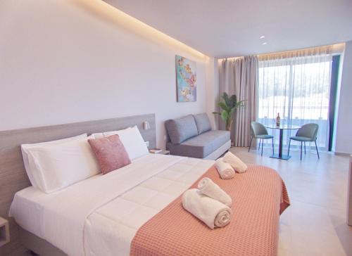 a hotel room with a large bed and a table at Melina Apartments Sea & City in Chania Town