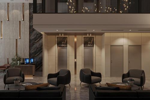 a lobby with couches and chairs in a building at Nature Hotel - Lac Long Quan in Hanoi