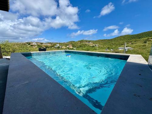 a swimming pool with a cross in the background at The Hangover Block in Culebra