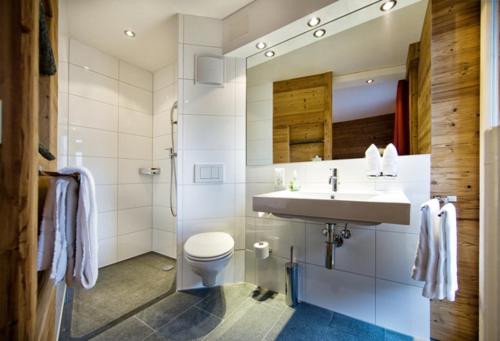 a bathroom with a sink and a toilet at Arosa Vetter Hotel in Arosa