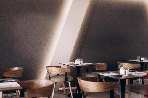 a restaurant with tables and chairs in a room at Zorbas Lifestyle Hotel in Georgioupolis