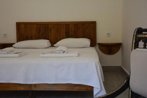 a bedroom with a bed with two towels on it at İlçayto Rooms in Foca